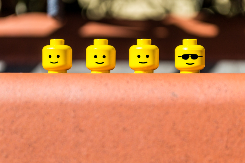Florence, Italy - February 27, 2015: Lego mini figure heads are looking at the camera. Different head wearing glasses.
